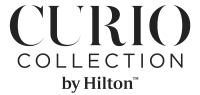 The image shows the logo for "Curio Collection by Hilton," featuring bold lettering in a minimalist style.