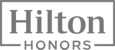 The image shows the "Hilton Honors" logo in a simple, rectangular design with bold letters.