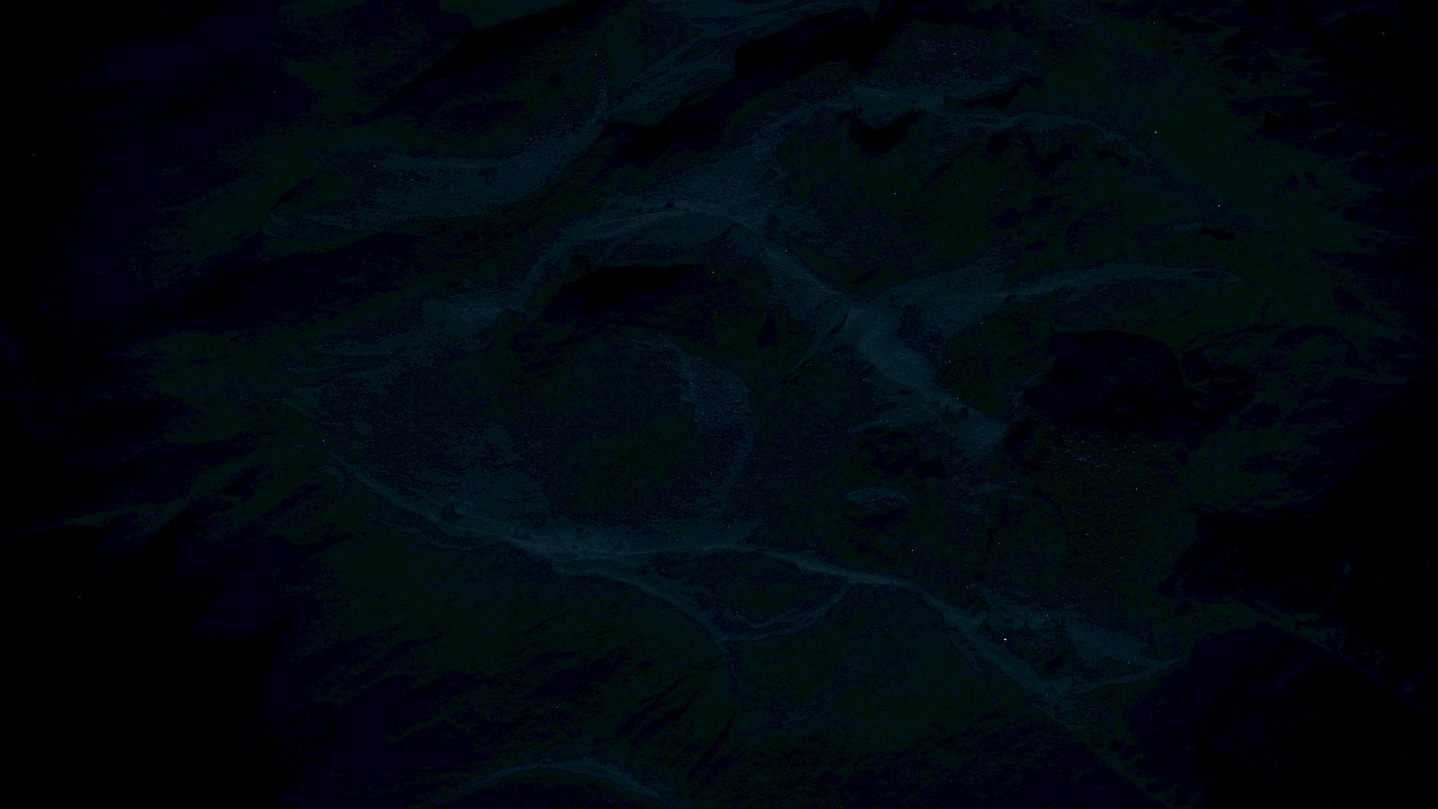 The image is very dark, making it difficult to discern any specific details or objects.