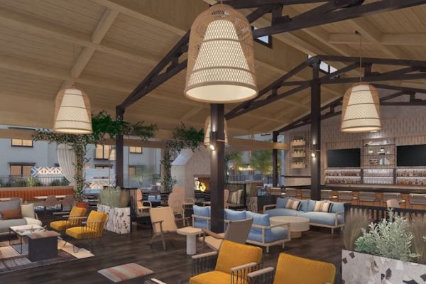 A modern lounge with cozy seating, warm lighting, and wooden accents. Features include a bar area and a fireplace.